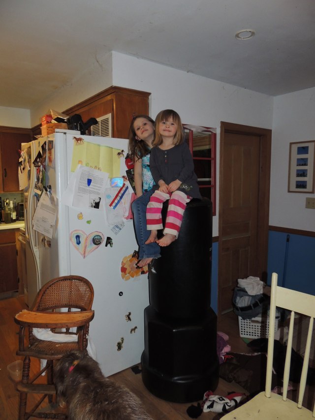 girls sitting on punching bag