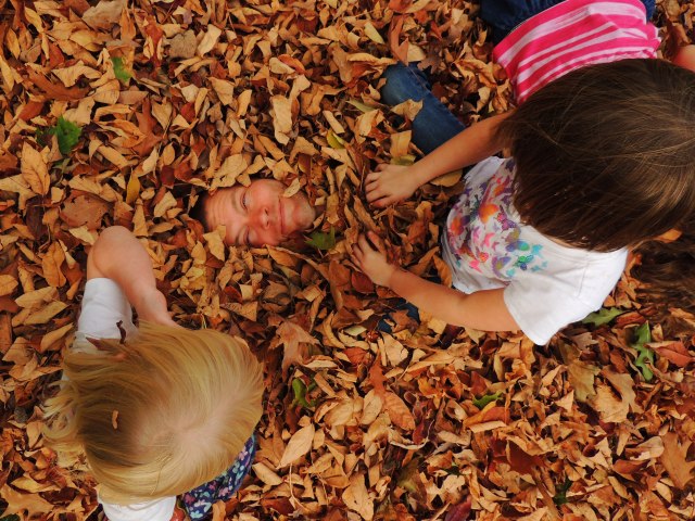 John in leaf pile