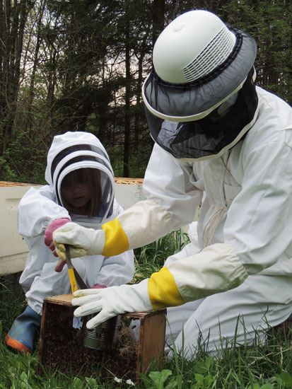 Clara and John open bee package