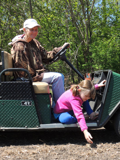 Clara and Mom pick rocks