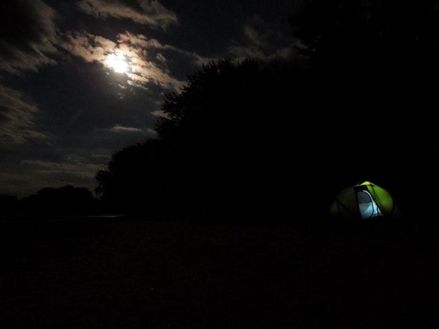 river campsite under full moon